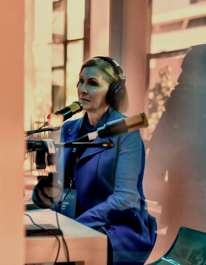 Tammy Hawes hosting a podcast in a recording studio